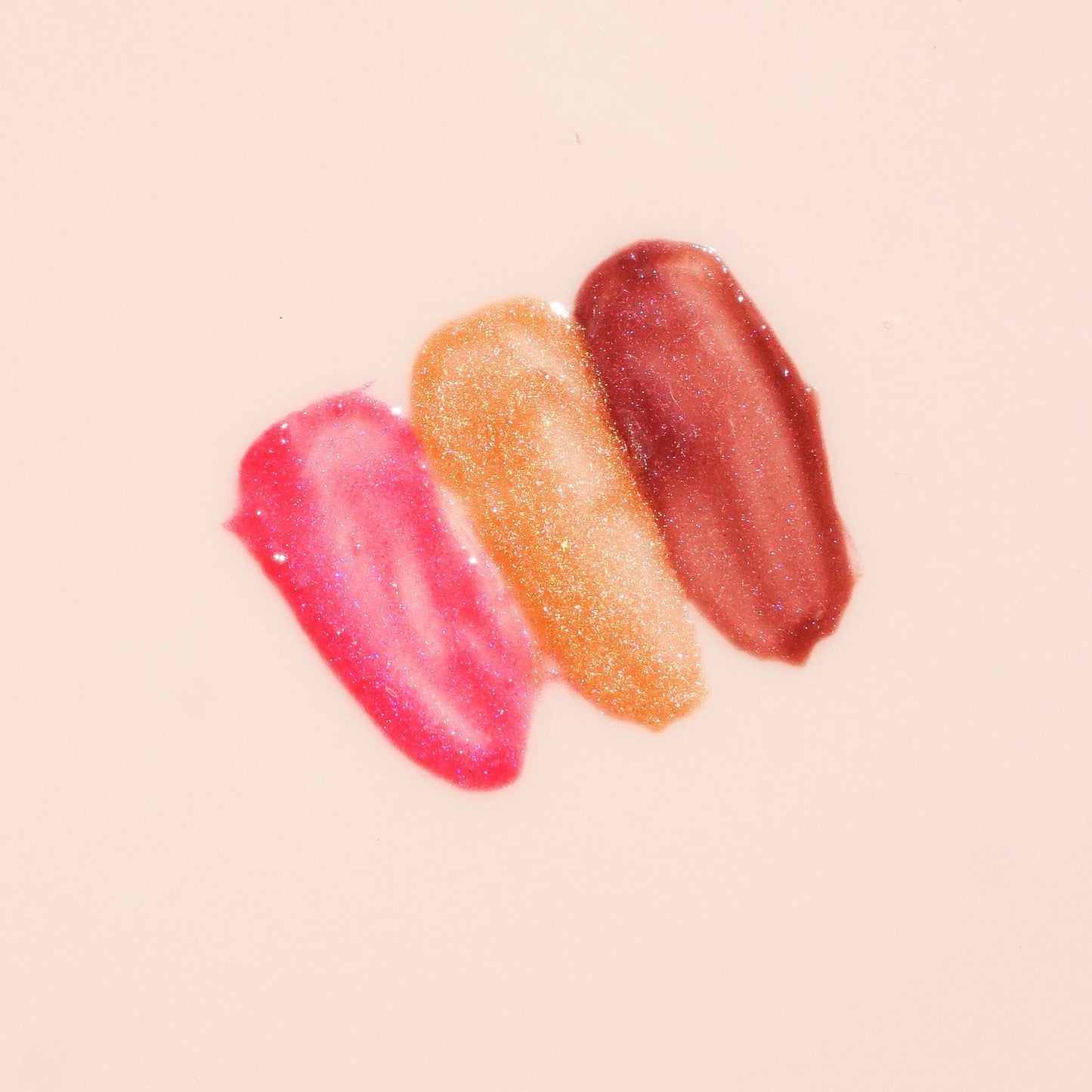 Close-up view of the True Moringa Lip Whip Trio Set, displaying three beautiful swatches of shades on a soft background.