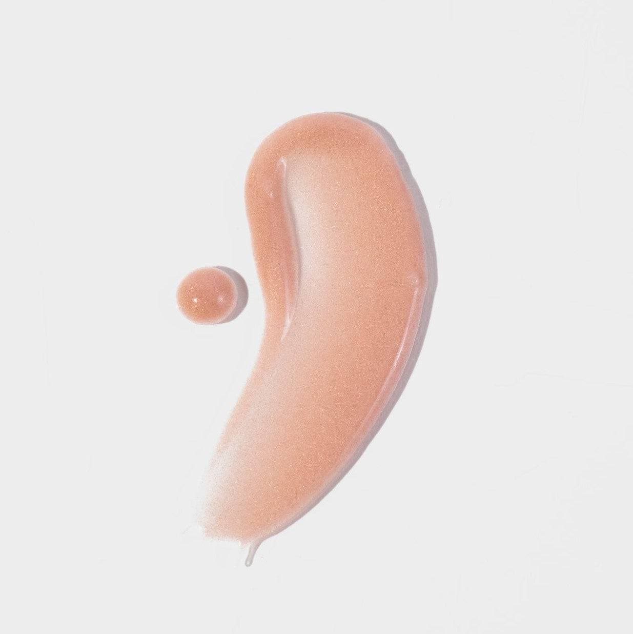 Swatch of Cosmedica Skincare Illuminating Rose Gold Facial Serum displaying its silky, light-reflective formula, ideal for enhancing skin luminosity.