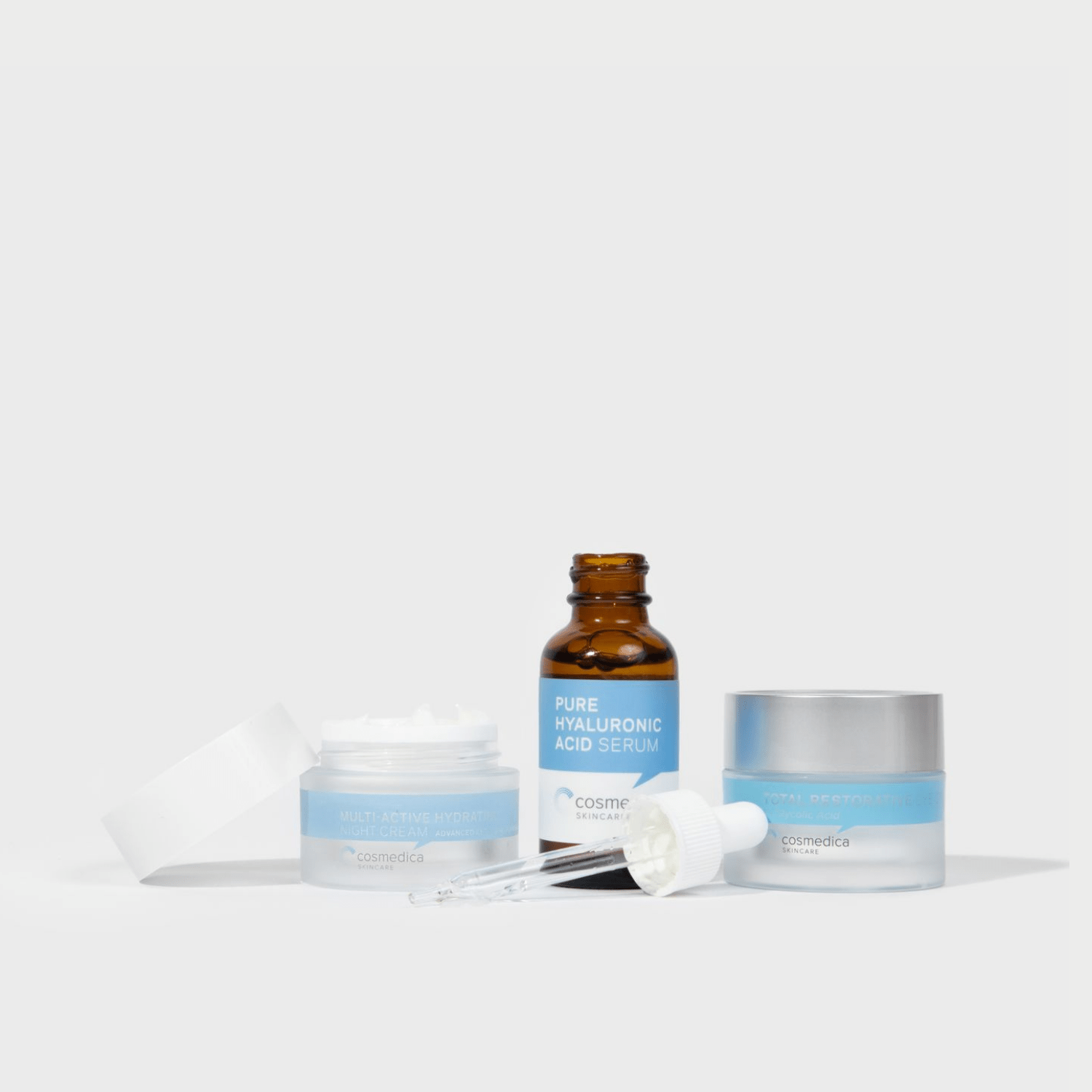 Cosmedica Skincare Intense Hydration Kit displaying Pure Hyaluronic Acid Serum, Multiactive Hydrating Night Cream, and Total Restorative Eye Cream, ideal for restoring moisture and vitality.