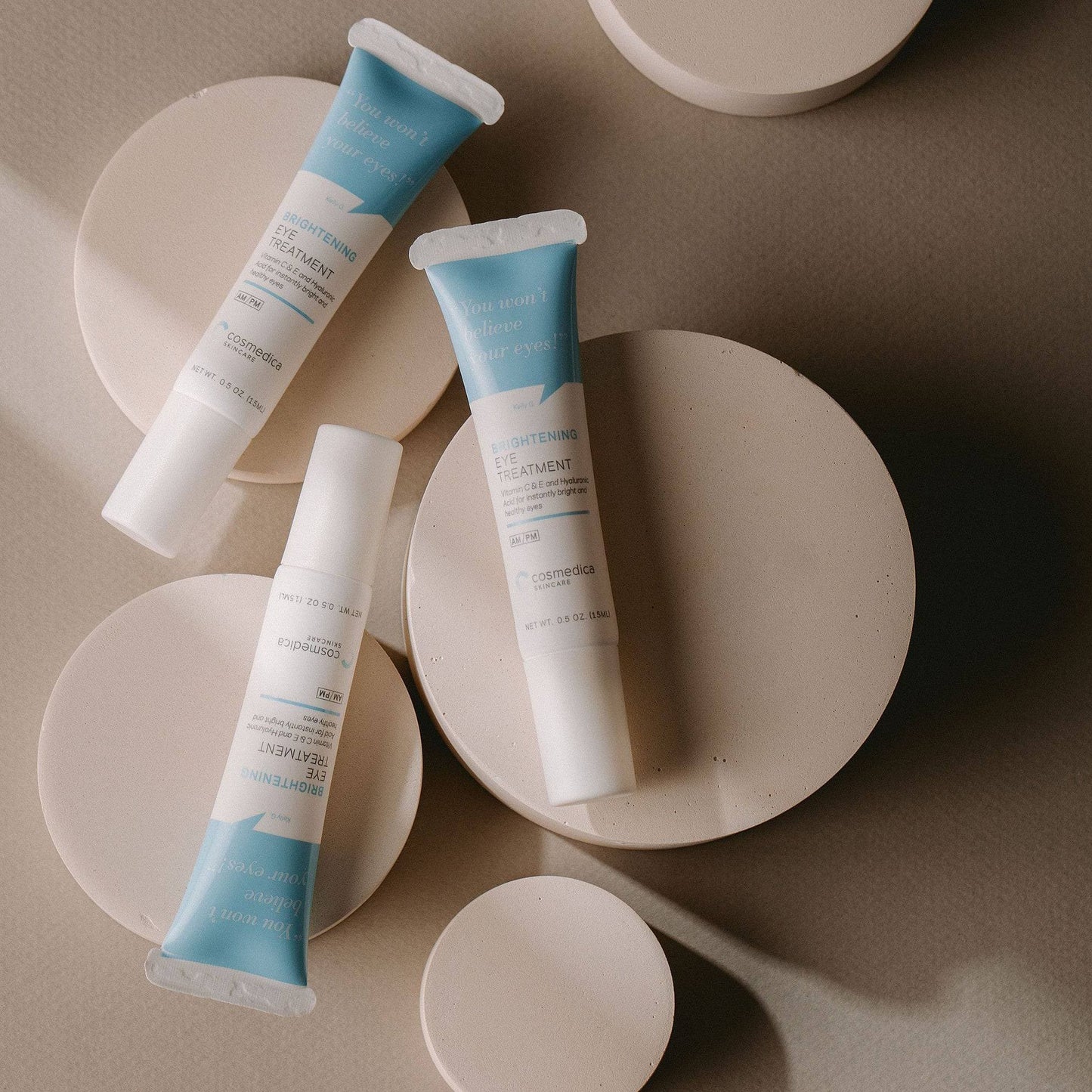 Cosmedica Skincare's Brightening Eye Treatment Gel alongside other products, showcasing a minimalist display perfect for skincare enthusiasts.