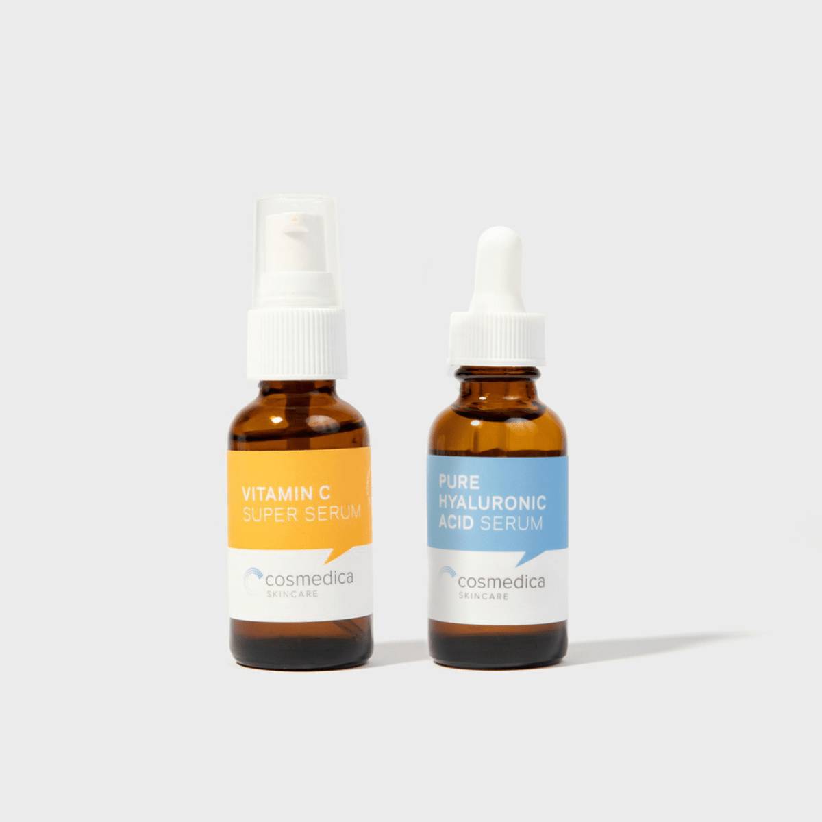 Hyaluronic + Vitamin C Serum Set by Cosmedica Skincare featuring Pure Hyaluronic Acid Serum and Vitamin C Super Serum in amber bottles.