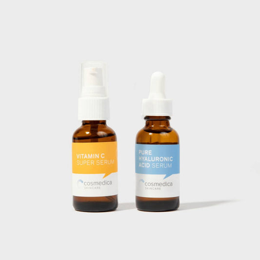 Hyaluronic + Vitamin C Serum Set by Cosmedica Skincare featuring Pure Hyaluronic Acid Serum and Vitamin C Super Serum in amber bottles.