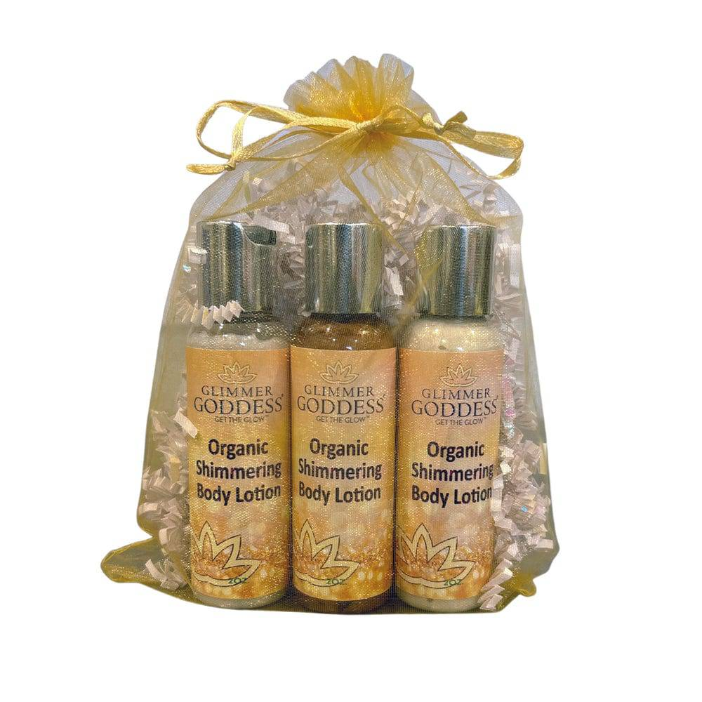 Travel size gift set of Organic Shimmer Body Lotion by GNS Beauty & Personal Care, featuring three sparkling body lotions in a decorative bag.