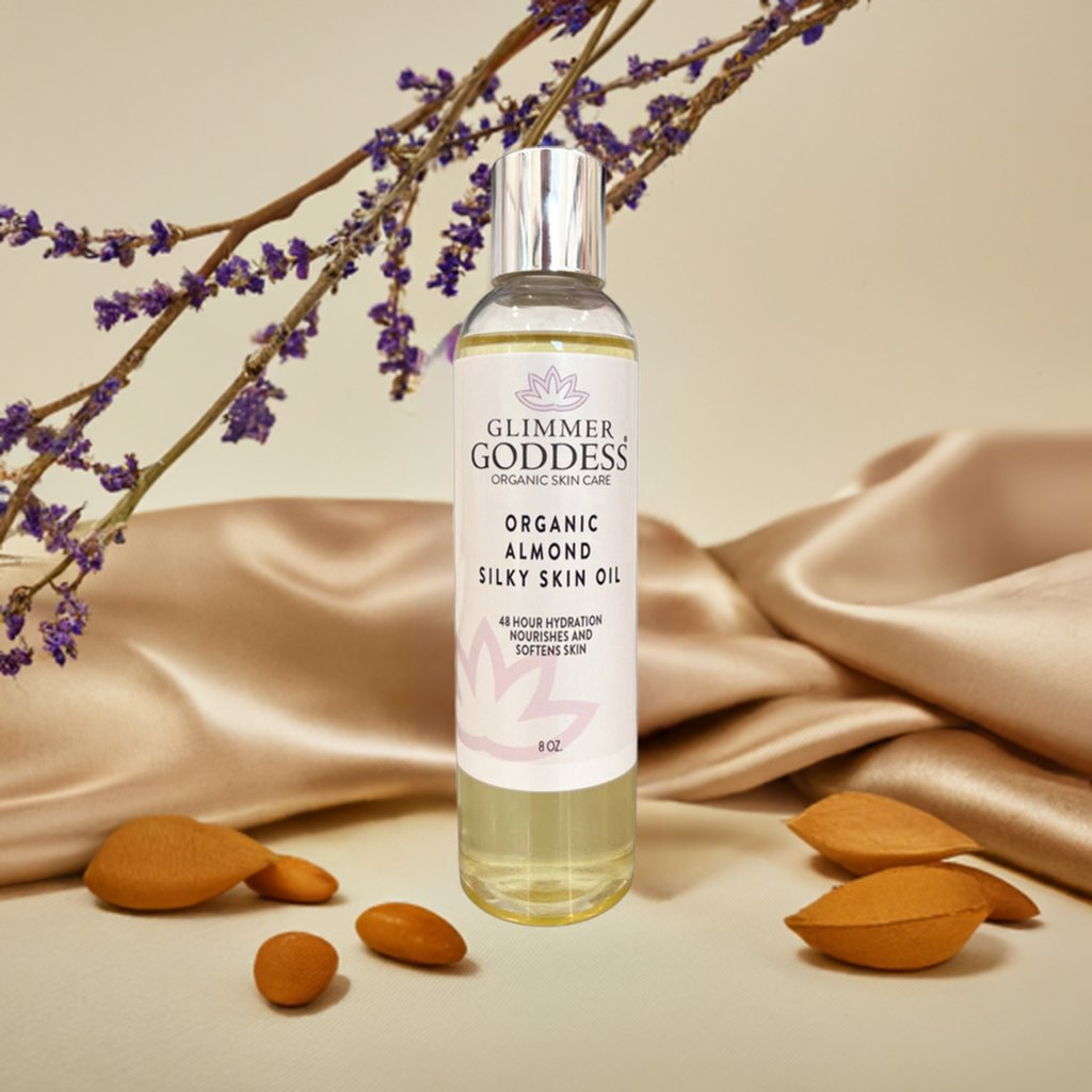 Glimmer Goddess Organic Sweet Almond Silky Skin Oil displayed with lavender and almonds, highlighting its hydration benefits and soothing properties.
