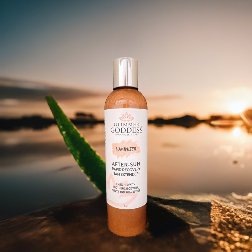 Glimmer Goddess Organic After Sun Lotion displayed near a serene water body at sunset, emphasizing its Tan Extender & Luminizing Shimmer, by GNS Beauty & Personal Care.