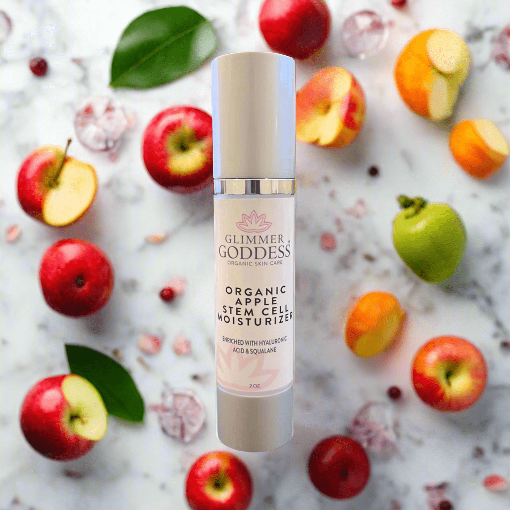 Glimmer Goddess Organic Apple Stem Cell Renewal Moisturizer displayed with fresh apples and vibrant greenery by GNS Beauty & Personal Care.