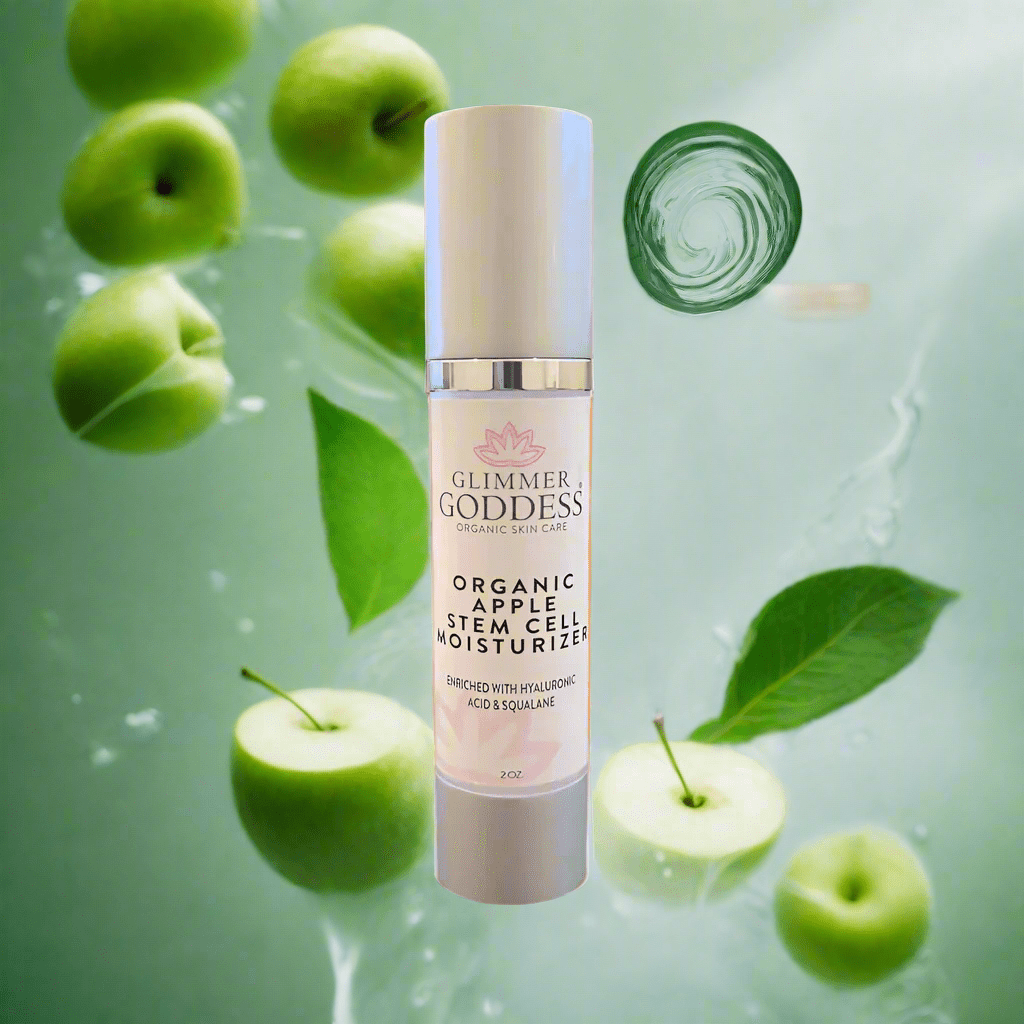 Glimmer Goddess Organic Apple Stem Cell Renewal Moisturizer surrounded by fresh green apples and leaves, highlighting organic skincare by GNS Beauty & Personal Care.