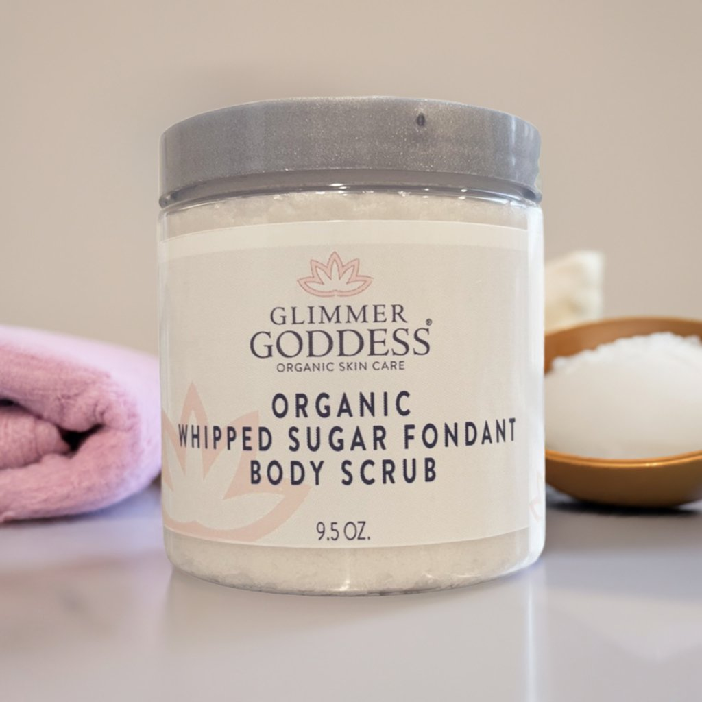 Glimmer Goddess Organic Whipped Sugar Fondant Exfoliating Body Scrub with soft towels and salt, perfect for luxurious skincare at home.
