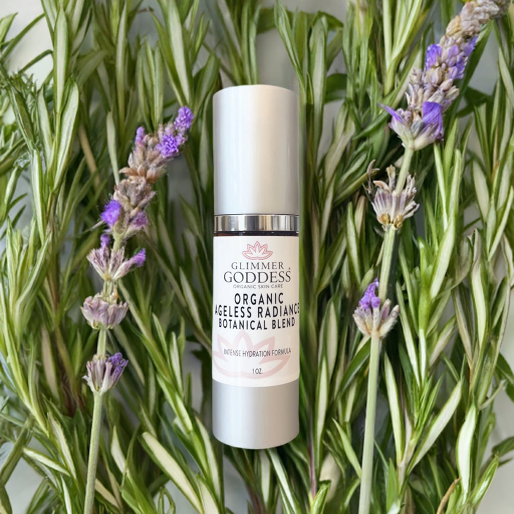 Glimmer Goddess Organic Skin Brightening Serum surrounded by fresh herbs, emphasizing its organic and botanical ingredients.