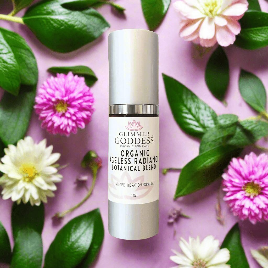 Glimmer Goddess Organic Skin Brightening Serum placed on a soft pink background with vibrant flowers, highlighting its promise of an ageless radiance and skin tone improvement.