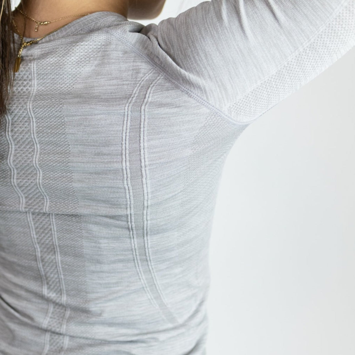 Back view of the DYM Athletics Trainer Lightweight Long Sleeve in light grey, showcasing breathable mesh construction and seam details.