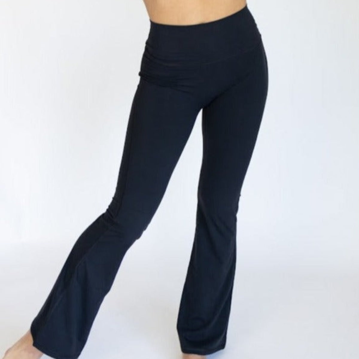 AIRE Ultra-Soft Flare High Waist Pants from DYM Athletics, displayed from the front. These fashionable flare pants offer comfort and support, ideal for workouts or casual outings.