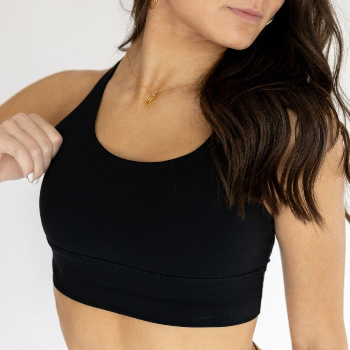 Close-up of a woman in the Zone Bra by DYM Athletics, emphasizing its sleek design and comfortable fit for activewear.