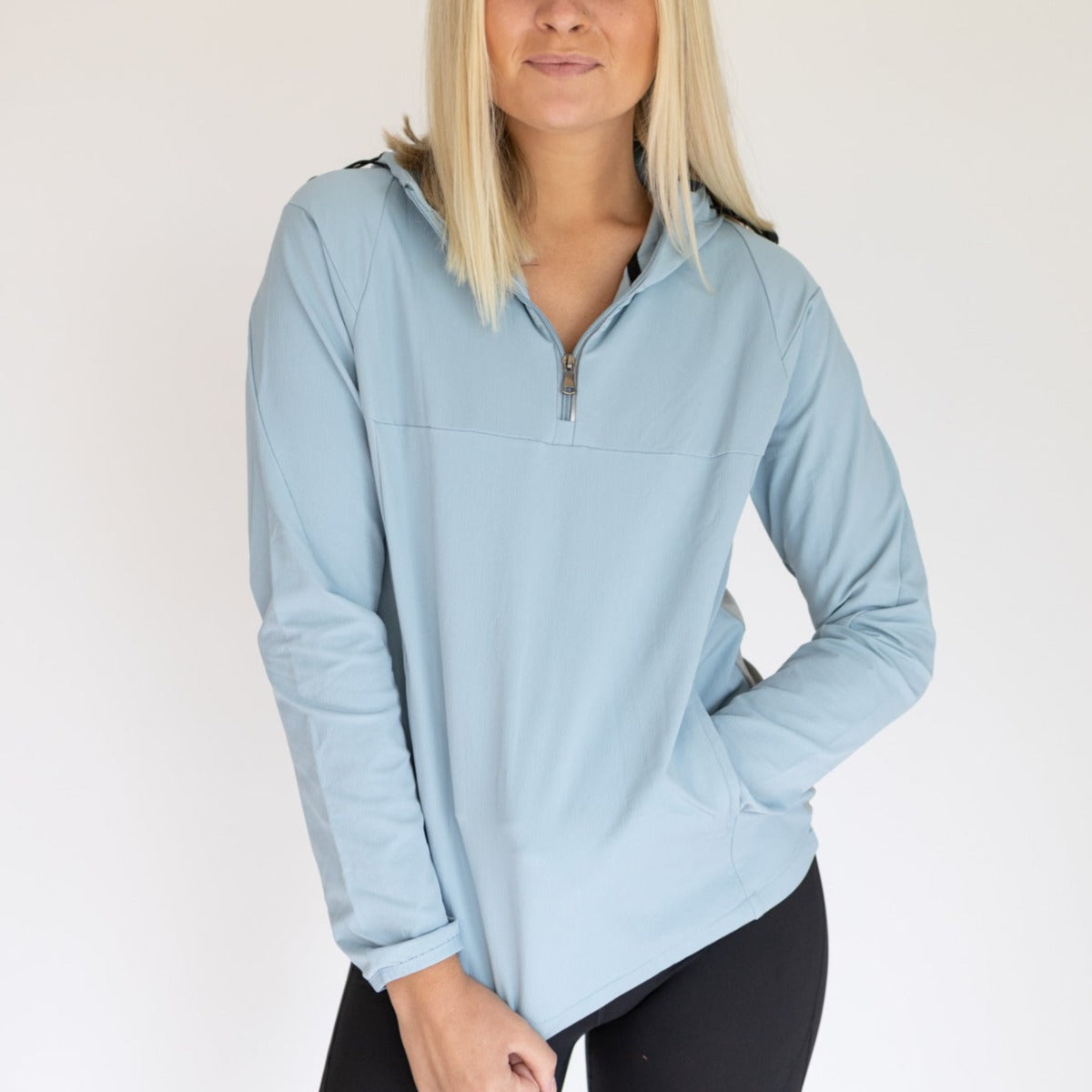 Women's Hiking Jacket by DYM Athletics in light blue, featuring a half-zip design and comfortable fit, perfect for outdoor adventures.