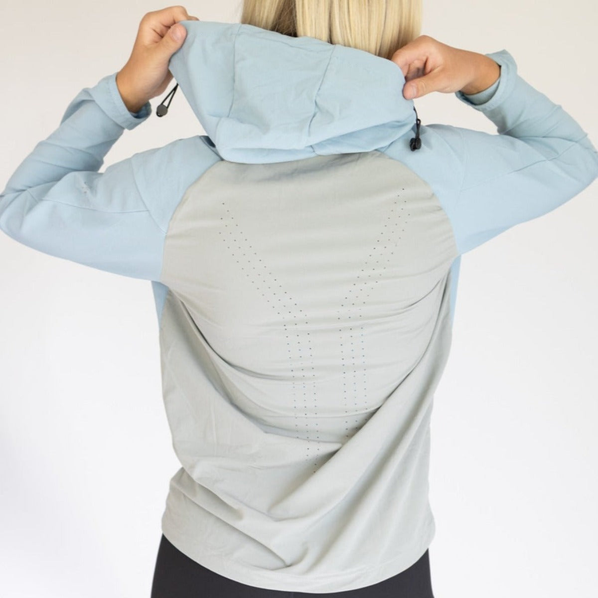 Back view of a women's hiking jacket from DYM Athletics, showcasing its lightweight, breathable design and stylish hood. Perfect for outdoor adventures and casual wear.