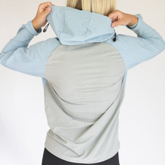 Back view of a women's hiking jacket from DYM Athletics, showcasing its lightweight, breathable design and stylish hood. Perfect for outdoor adventures and casual wear.
