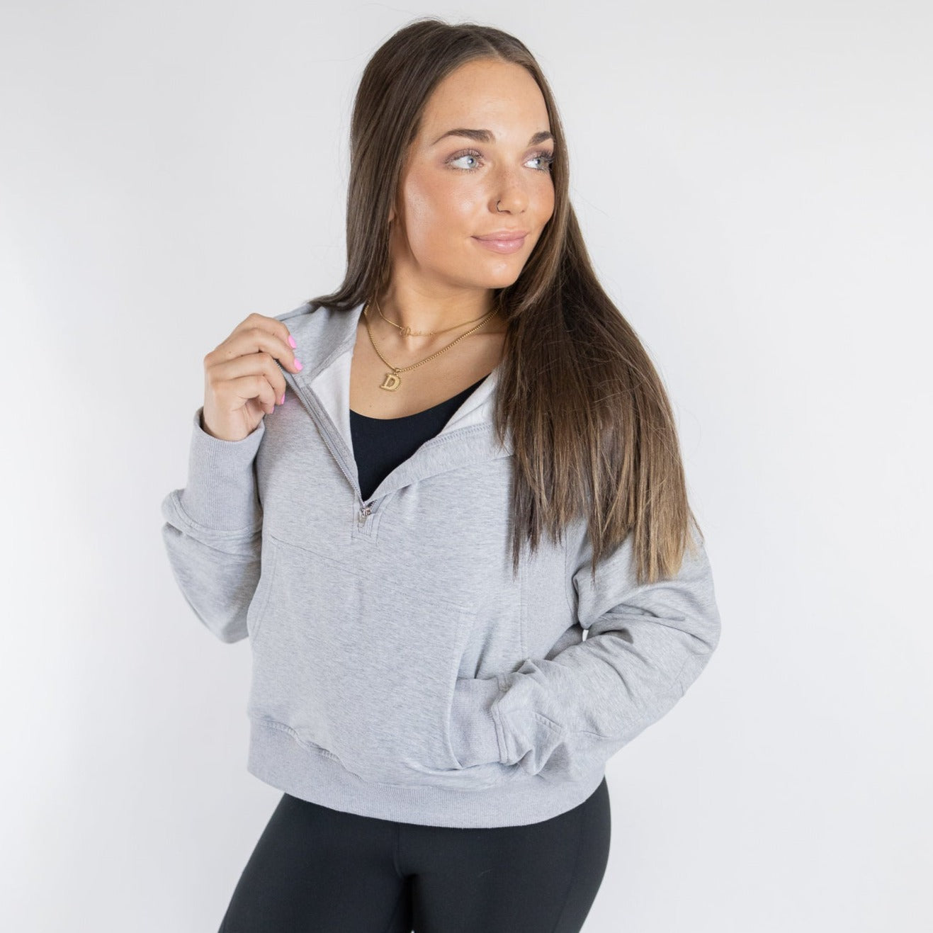Model displaying the gray Lightweight 1/4 Zip Hoodie by DYM Athletics, highlighting its cozy fit and convenient zip design.