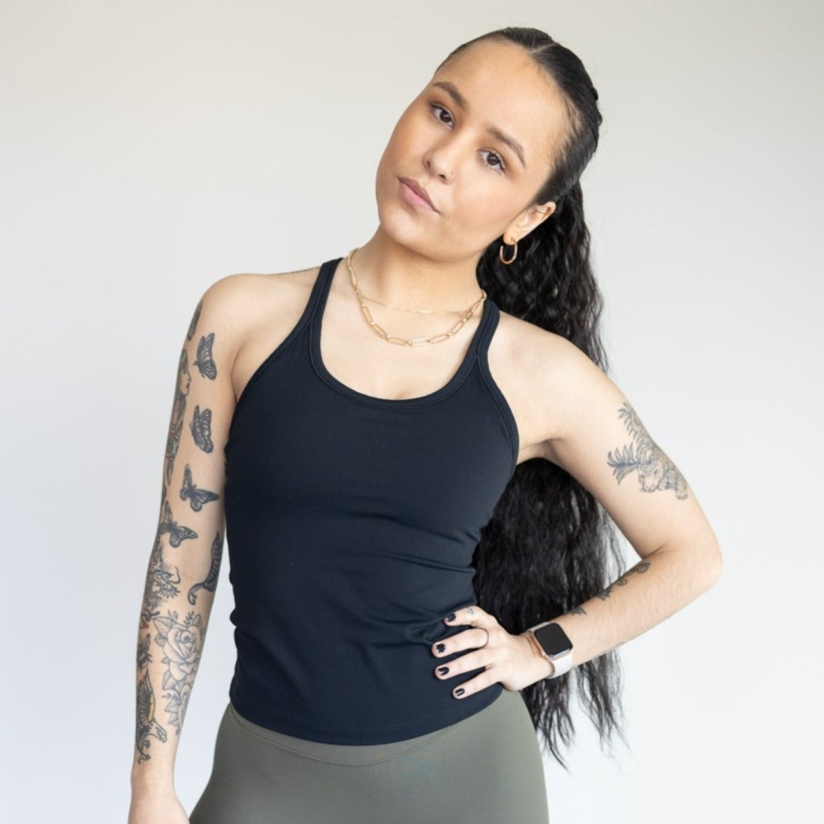 Front view of a woman modeling the Energy Full Length Everyday Tank by DYM Athletics, featuring a sleek fit and comfortable style suitable for any activity.