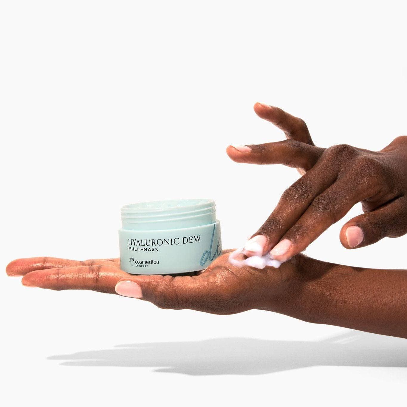 Hand applying Hyaluronic Dew Multi-Mask from Cosmedica Skincare, emphasizing the product's soothing and hydrating properties.