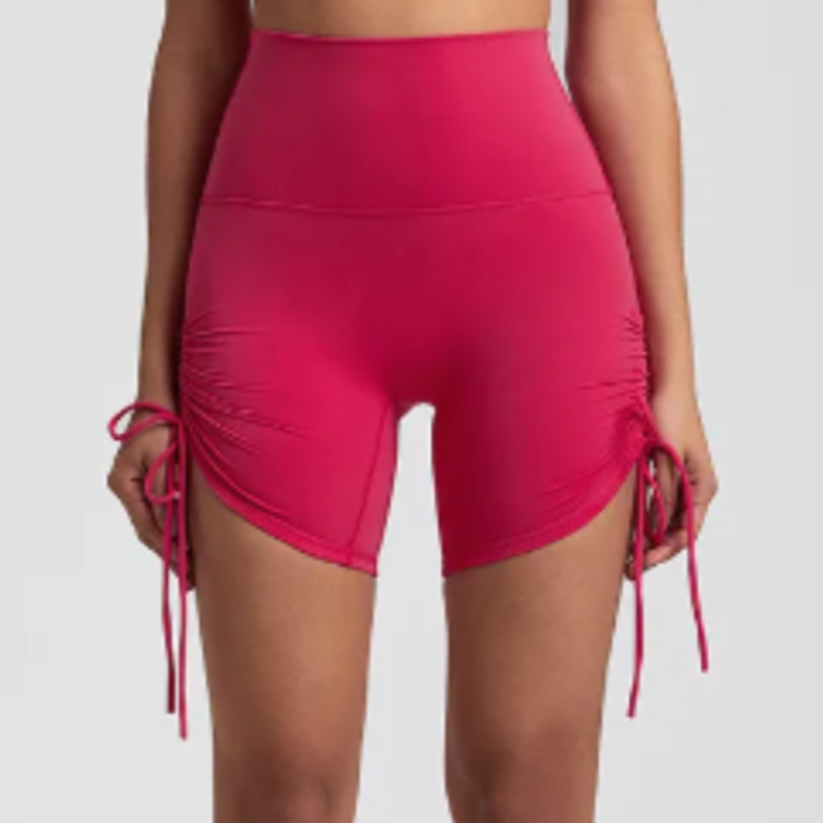 DYM Athletics Ultra-Soft Ruched Biker Shorts in a striking pink color, featuring customizable ruching for comfort during medium to high impact activities.