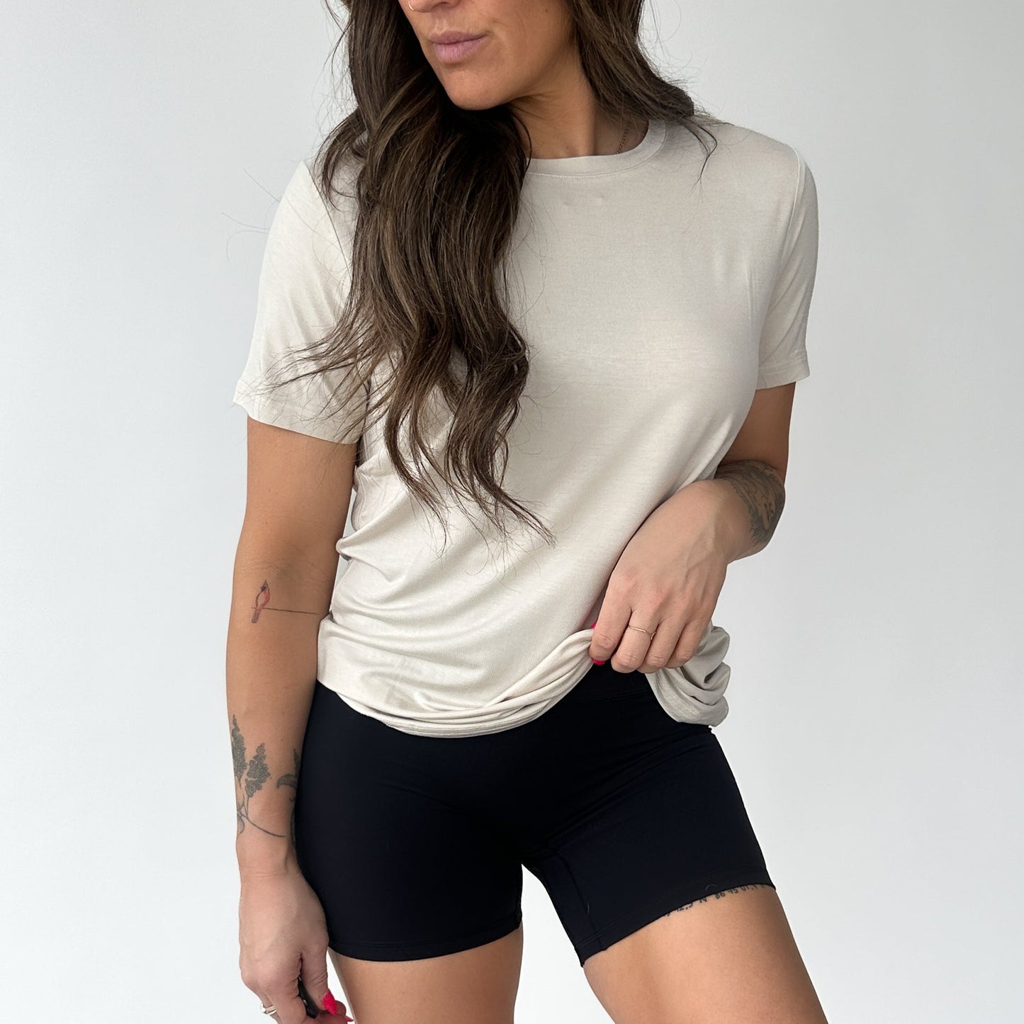 Female wearing a beige Breathe Bamboo T-Shirt by DYM Athletics, illustrating versatility and comfort for everyday wear.