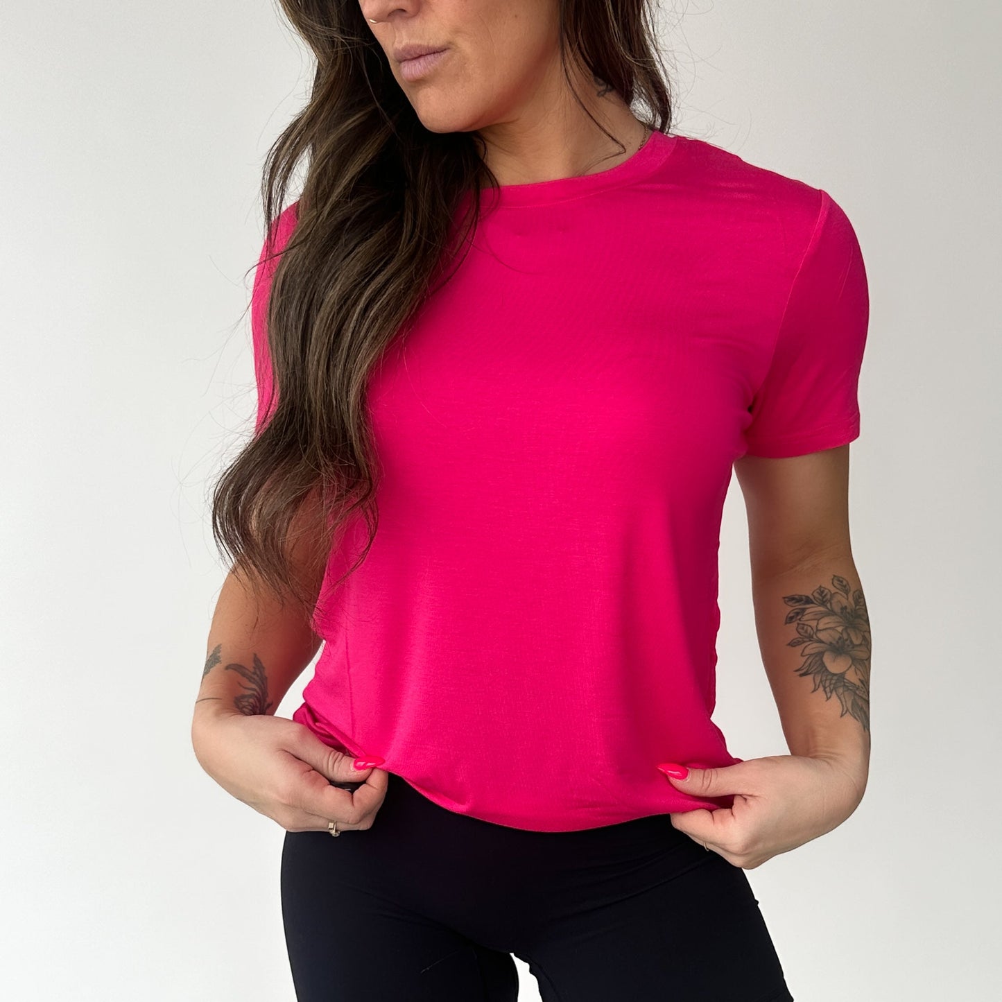 Model showcasing the Breathe Bamboo T-Shirt in vibrant pink by DYM Athletics, perfect for stylish comfort.