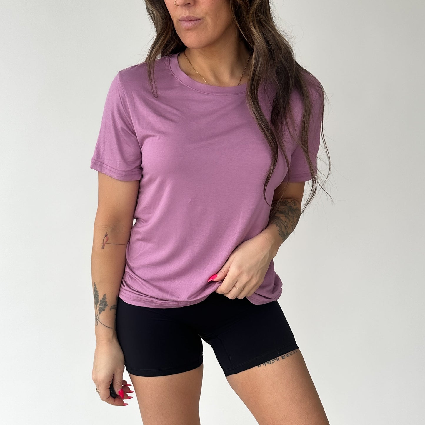 Woman in a pink Breathe Bamboo T-Shirt from DYM Athletics, highlighting the soft fabric and casual look.