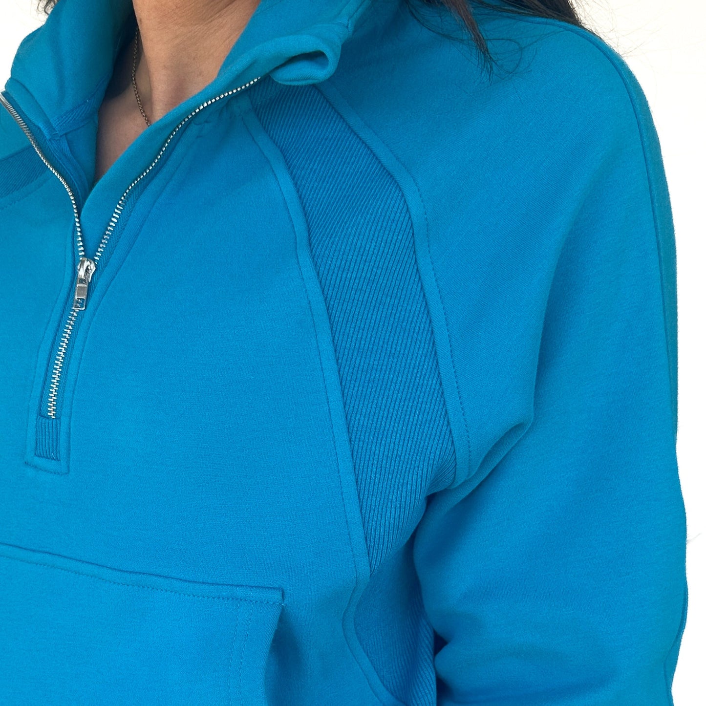 Close-up of the Cozy Up Full Length 1/2 Zip Sweatshirt by DYM Athletics, featuring detailed stitching and texture of the vibrant blue fabric, emphasizing style and comfort.
