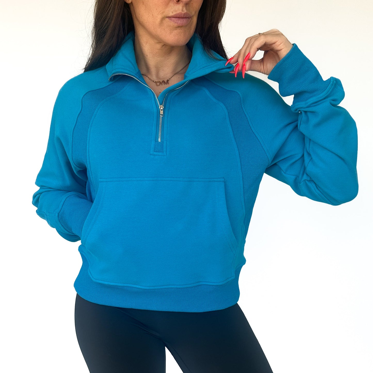 DYM Athletics Cozy Up Full Length 1/2 Zip Sweatshirt, model posing confidently in a blue sweatshirt with adjustable 1/2 zip, highlighting its chic and relaxed look.