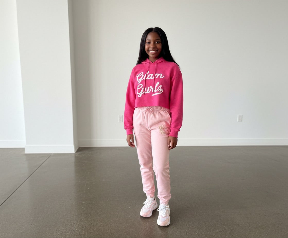 Young girl smiling and wearing the Customized Glam Gurls Cropped Hoodie with Puff Print in soft pink, highlighting a fun and stylish look by Glam Gurls.