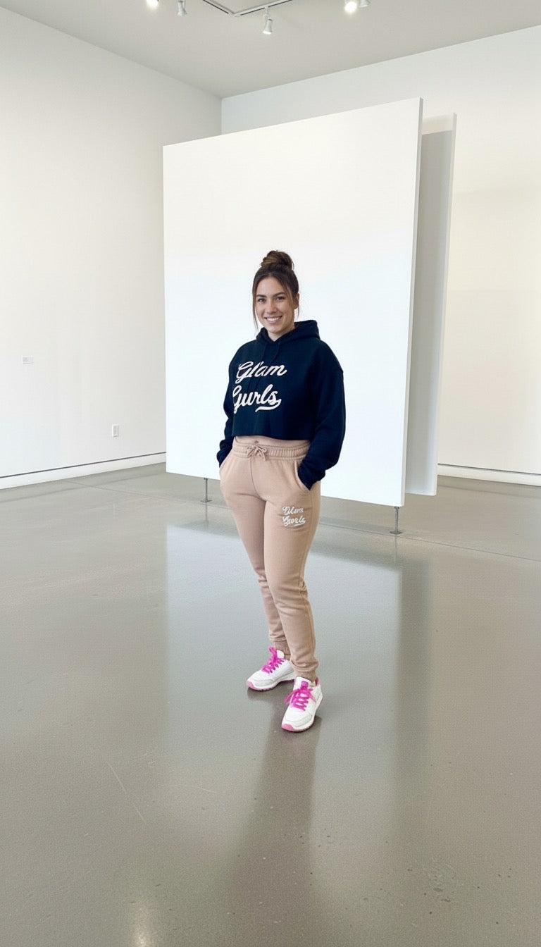 Close-up of model in Customized Glam Gurls Cropped Hoodie with Puff Print, featuring beige joggers and bright sneakers, set in a chic environment. Perfect for lounging from Glam Gurls, sizes S-XL.