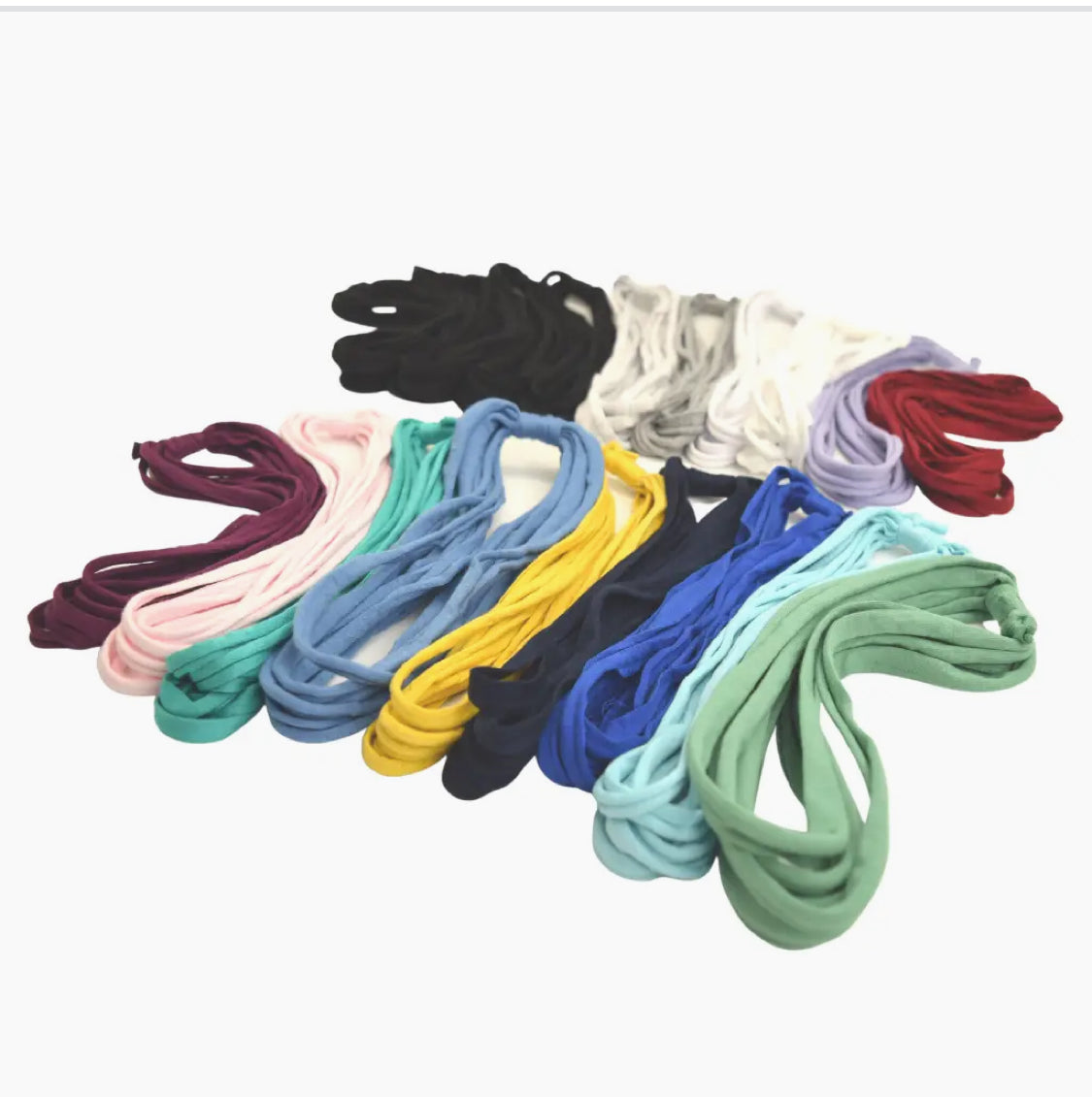Variety of colorful Bela Band Headbands displayed together, showcasing the range of eco-friendly styles from Bela Band.