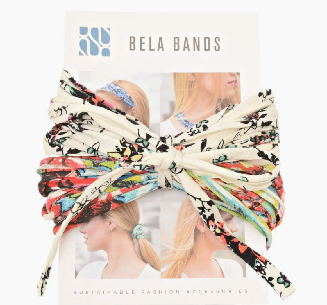 A collection of Bela Band Headbands in colorful floral and patterned designs, packaged for sustainability and style by Bela Band.