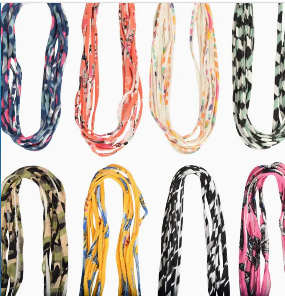 An array of Bela Band Headbands and scrunchies in vibrant colors and patterns, perfect for versatile styling by Bela Band.