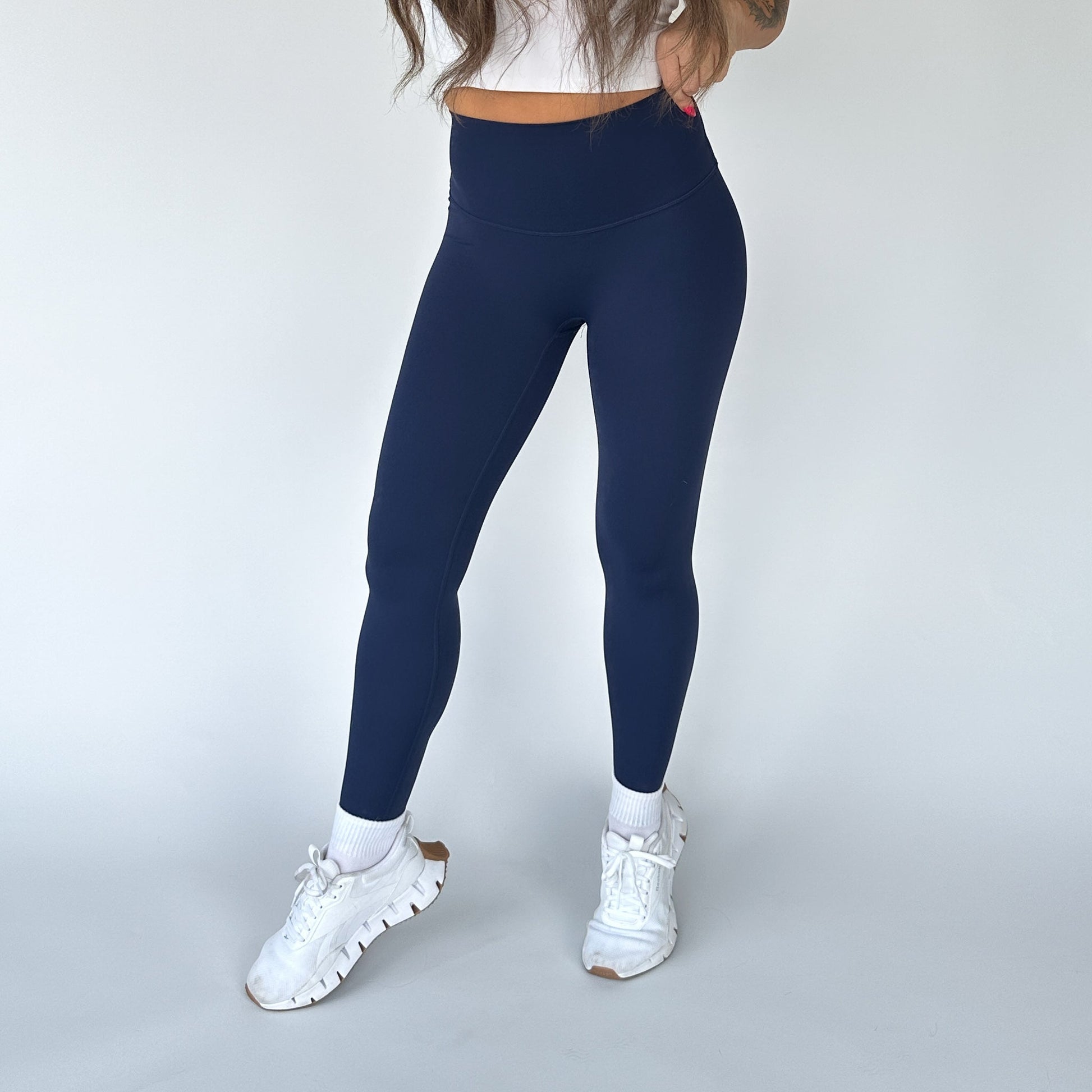 DYM Athletics Buttery Soft Seamless Leggings in navy blue, providing a stylish and supportive option for active lifestyles.
