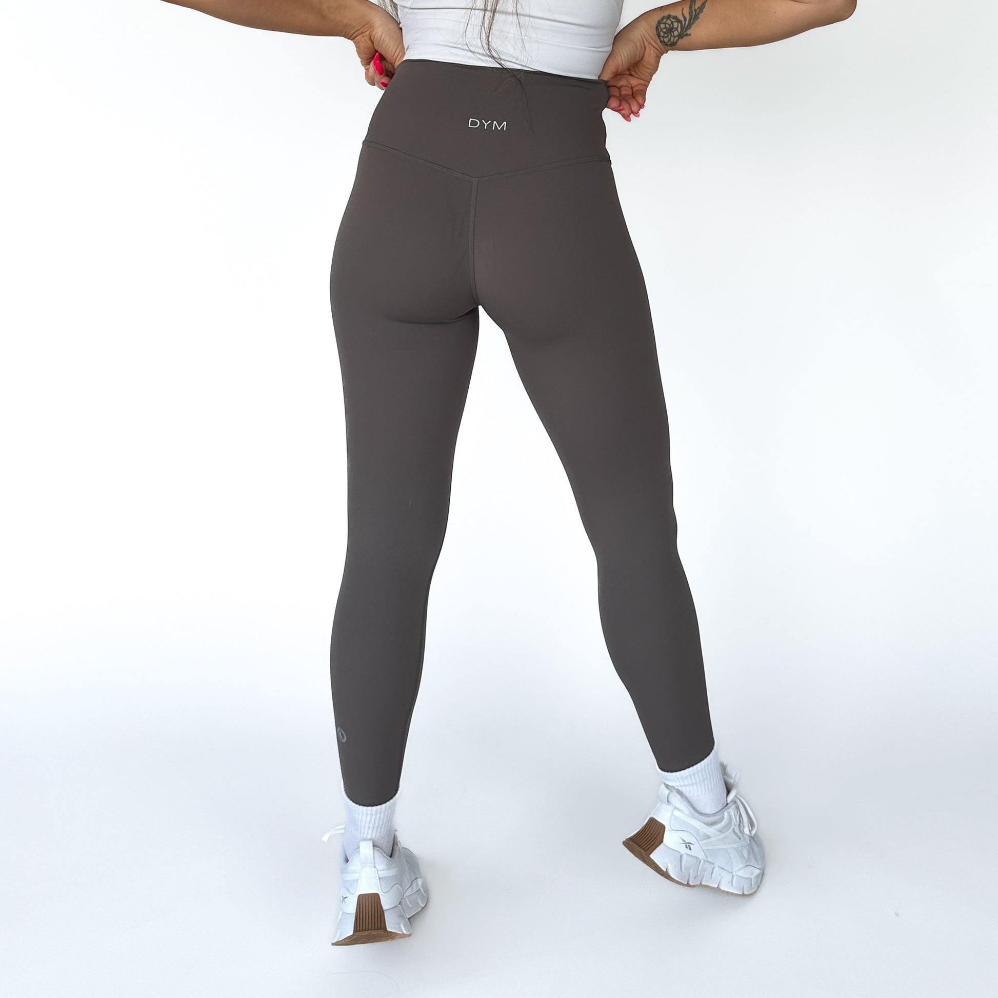 DYM Athletics Buttery Soft Seamless Leggings in dark brown, highlighting the seamless construction and supportive design, viewed from the back.