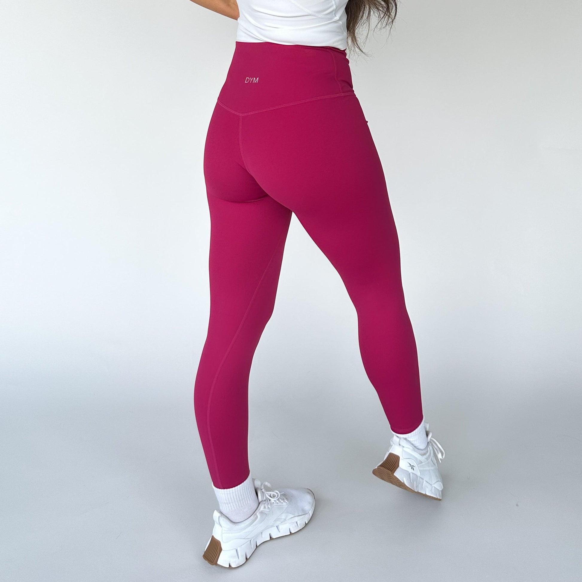 Back view of bright pink Buttery Soft Seamless Leggings by DYM Athletics, designed for a flattering fit and comfort during workouts.