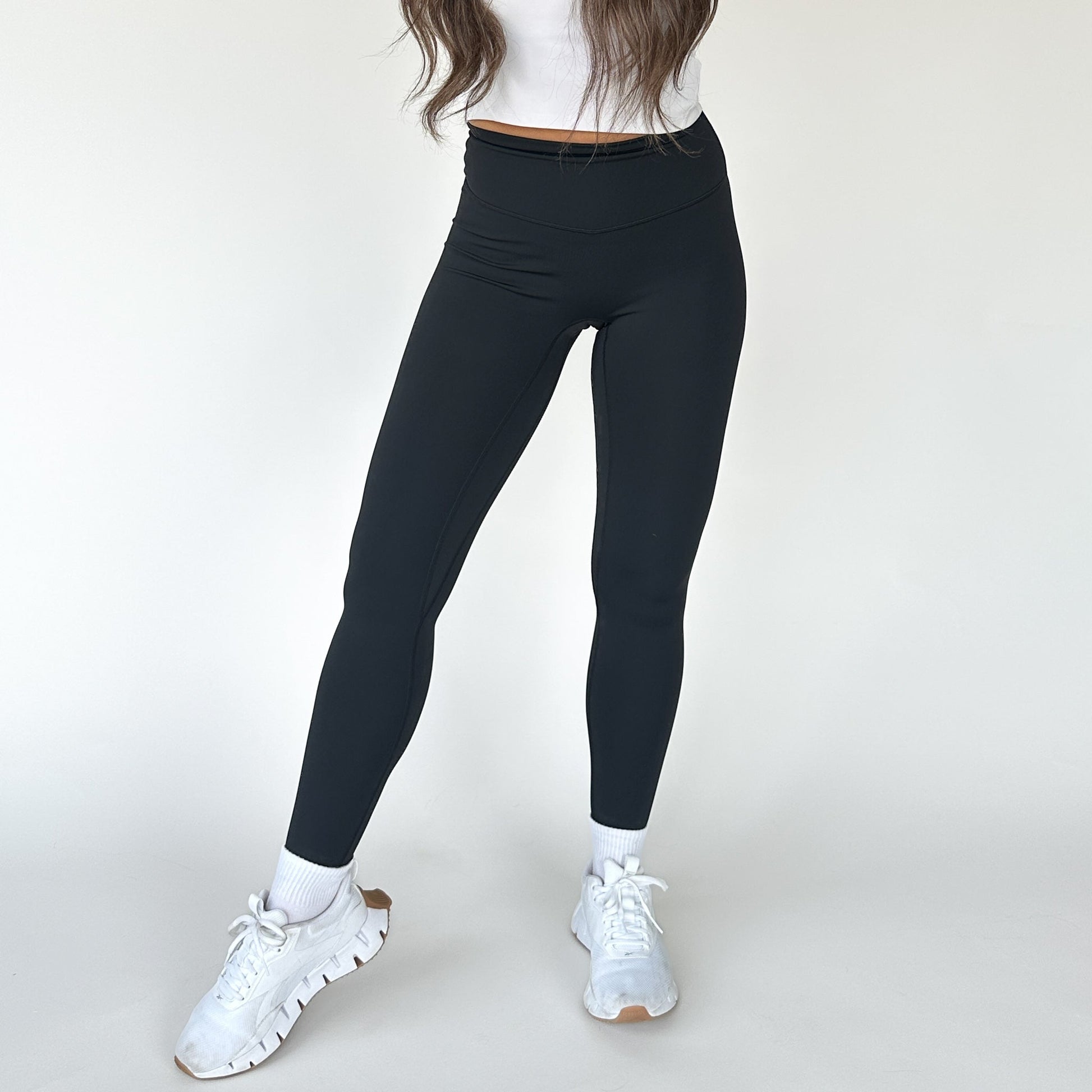 Front view of a model in High Society Sculpting Legging from DYM Athletics, demonstrating a sleek design that enhances movement and comfort.
