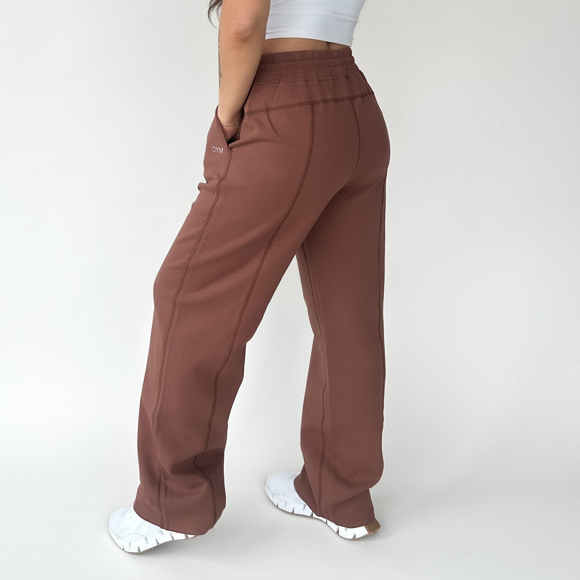DYM Athletics Relax Wide Leg Sweatpant with Cinch Drawstring, showcasing a model from the back wearing brown sweatpants, perfect for lounging or casual outings.