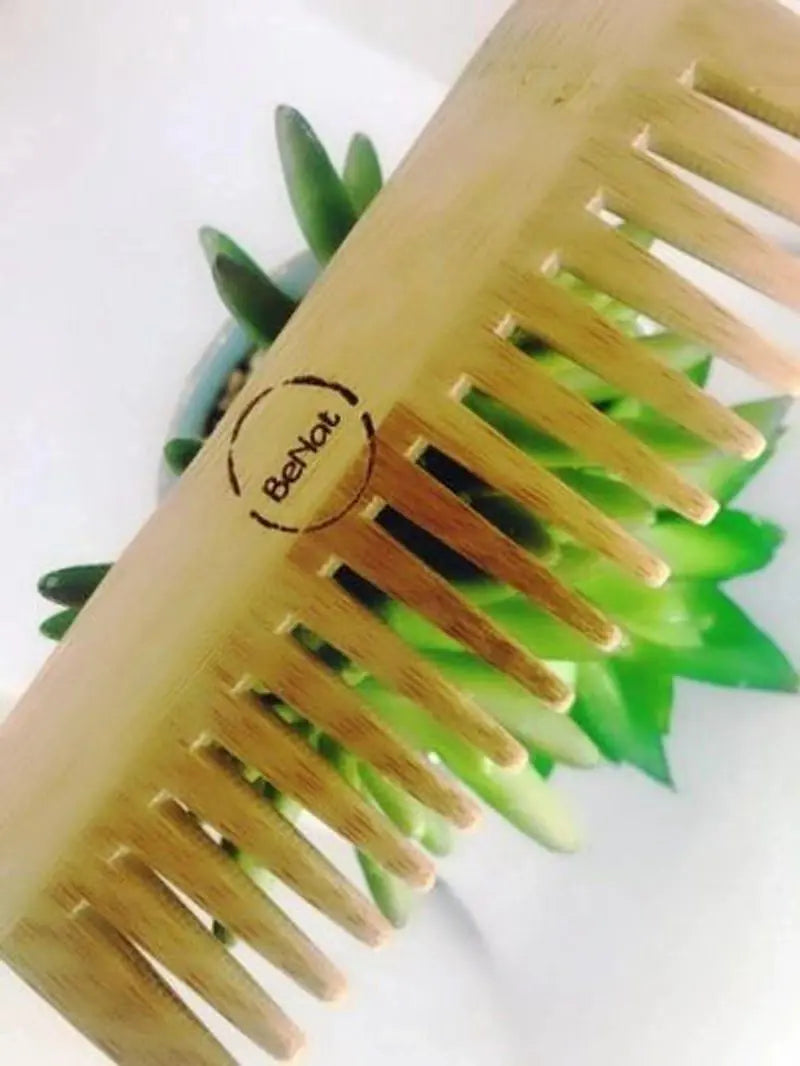 BeNat Eco-Friendly Bamboo Hair Comb on a background of greenery, illustrating its commitment to a sustainable and zero-waste lifestyle.