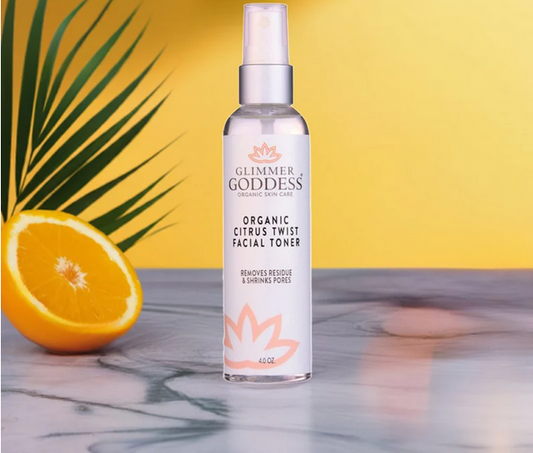 GNS Beauty & Personal Care Alcohol-Free Organic Citrus Facial Toner Mist bottle with Aloe Vera & Rose Water, displayed alongside a fresh orange on a marble surface.