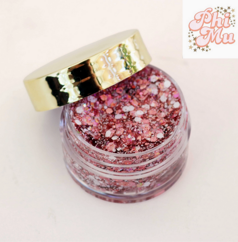 Go Greek Face Glitter Set by Stinaface offering a shimmery pink glitter collection in a clear jar with a gold lid, a great choice for Phi Mu gatherings.