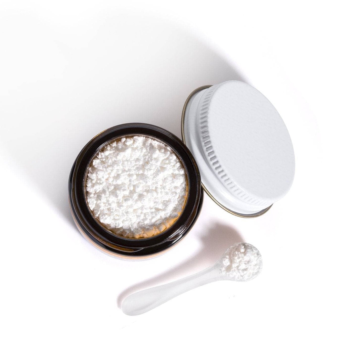 Close-up of Cosmedica Skincare Super C-Boost jar with lid off, revealing powder texture for skin brightening.