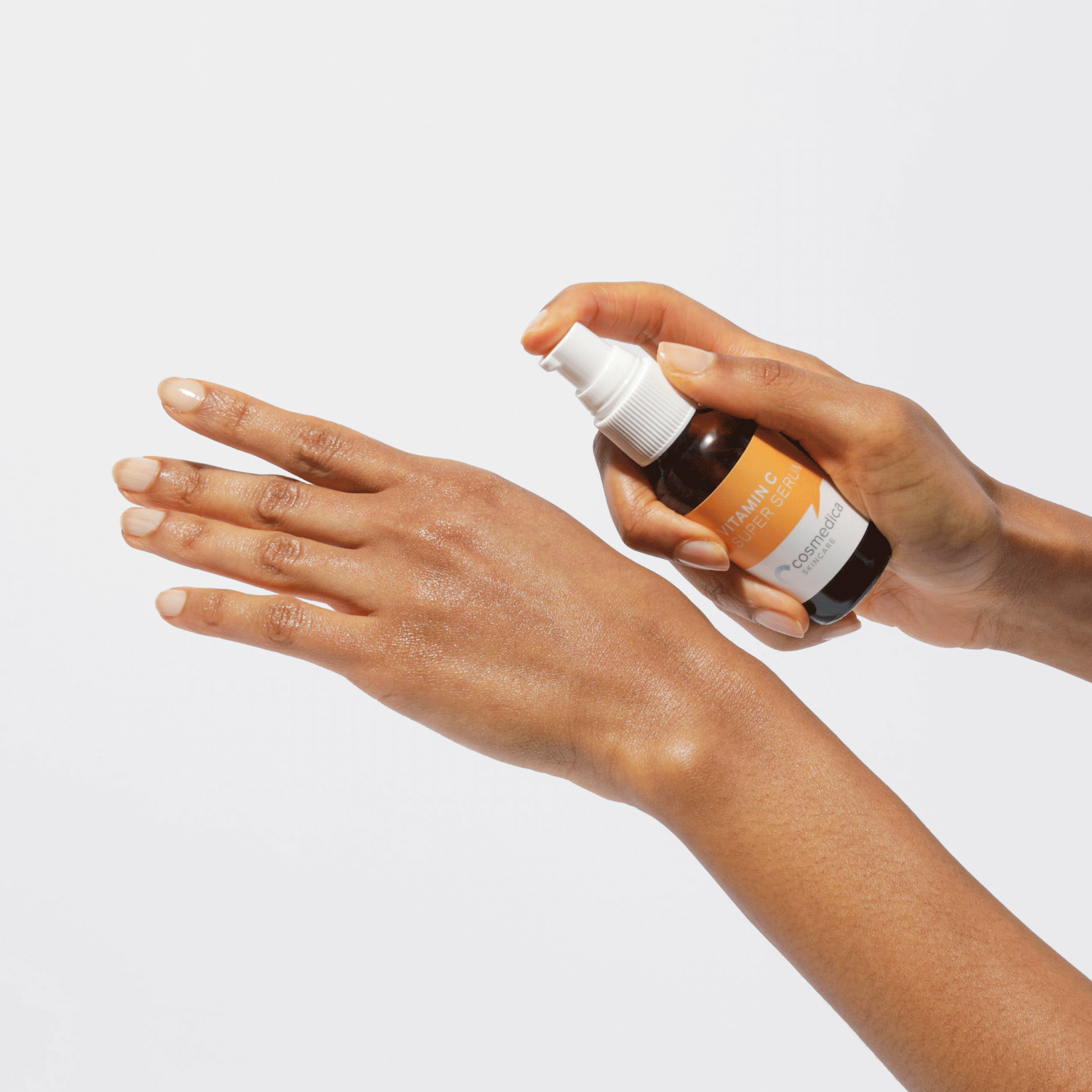 Application of Cosmedica Skincare Vitamin C Super Serum on a hand, highlighting the serum's texture and ease of use.