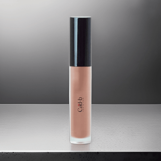 Nude LG06 Lip Gloss by GNS Beauty & Personal Care, showcasing a sleek, elegant packaging on a reflective surface, ideal for achieving radiant lips.